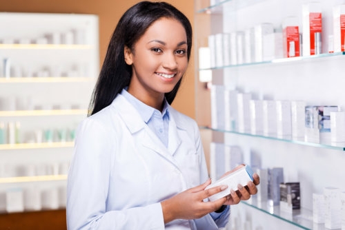 pharmacist holding a box of medicine